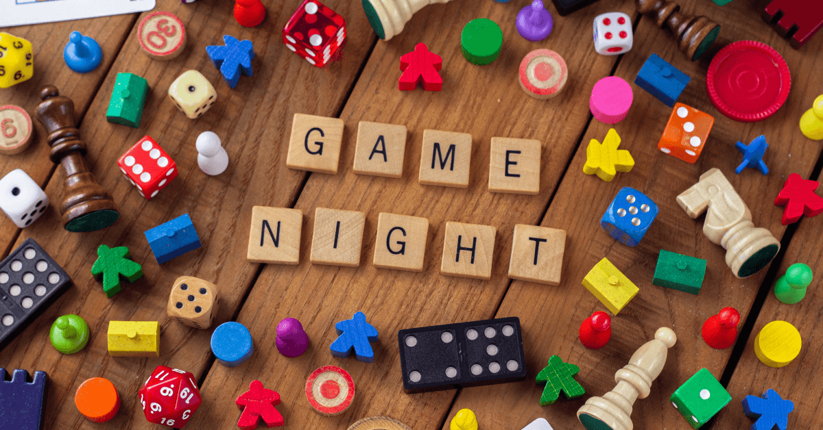 Game night spelled out in letter tiles with game pieces surrounding it.